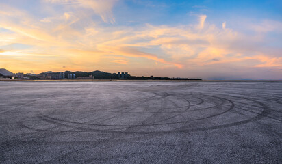 Wall Mural - Asphalt road square and coastline with beautiful sky clouds nature landscape at sunset. Outdoor asphalt parking lot.