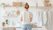 © Winter KD - Woman standing in laundry room Ironing and taking care of the neatness of the clothes.