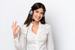 © luismolinero - Telemarketer caucasian woman working with a headset isolated on white background showing ok sign with fingers