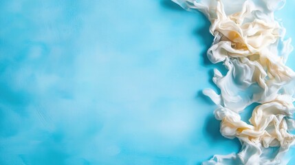 Poster - Soft White Fabric Flowing Elegantly on a Blue Background Surface