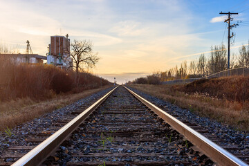 Wall Mural - A railroad track with a building in the background