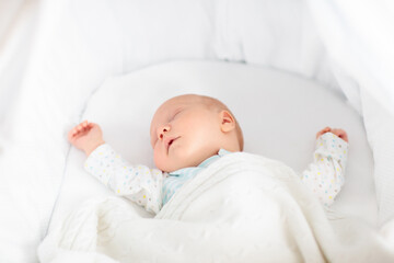 Wall Mural - Cute newborn baby in white bed