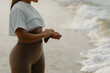 © Mirrorstudio - Young hispanic female enjoying beach walk in casual attire