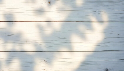 Wall Mural - Wooden planks with a light blue-gray color and visible wood grain, with shadows from overhead foliage creating a dappled pattern across the surface.