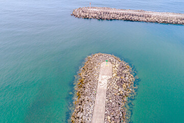 Fototapete - entrance of a harbor protected from the sea by two breakwaters, aerial view with drone