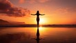 © V Art - Beach at sunrise or sunset, with a young woman's silhouette standing with arms outstretched. The sky is painted with warm hues of orange and pink.