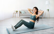 © Prostock-studio - Athletic Indian woman doing exercises on yoga mat, strengthening her abs muscles at home. Attractive Eastern lady staying fit and healthy indoors. Domestic sports concept