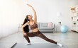© Prostock-studio - Flexibility exercises for healthy living. Fit Indian woman stretching her body during home workout, copy space. Sporty young Eastern lady training indoors, leading active lifestyle