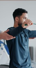 Wall Mural - Physical therapy, man and resistance band for stretching arms at clinic, helping hands and recovery. Physio, flexibility exercise and chiropractor for rehabilitation treatment, support and service