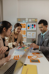 Digital product designers exchange ideas in their offices about how to design a website that meets the needs of today's users, who focus on ease of use and beautiful colors.