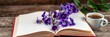 © Chalermrach - An open book filled with empty pages sits on a wooden surface decorated with spring blossoms, a cup of coffee, and violets, creating a romantic and inspiring image, stock photo, romantic idea