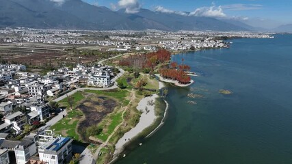 Poster - Stunning 4K aerial view of Erhai Lake in Dali, Yunnan, China.  The picturesque lakeside town showcases traditional architecture nestled against a backdrop of mountains.