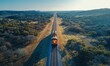 © EFA - A train travels along a straight track through a scenic landscape at sunset.