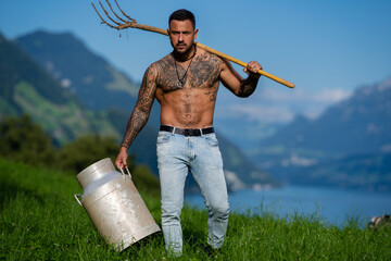 Wall Mural - Sexy Man farmer on countryside farm. Farmer with bare naked torso. Muscular sexy farm worker in the farm field. Strong shirtless Farmer on rural farm. Male farmer at his land.