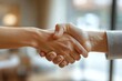 © jiawei - Two people shaking hands in a business setting