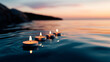 © Daniella - Four Tealight Candles Floating in Water at Sunset