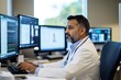 © Larisa - Focused doctor analyzing data on multiple computer screens