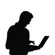 © adidesigner23 - Silhouette of person using laptop