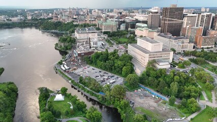 Wall Mural - Aerial footage of the buildings overlooking Ottawa River during daytime in Ottawa, Ontario, Canada