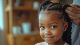 Dad styles hair by braiding six year old daughter\'s hair at home on a sunny afternoon