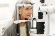 © Maria Vitkovska - Senior woman undergoing eye exam using phoropter in ophthalmology clinic