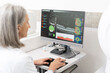 © Maria Vitkovska - Senior doctor analyzing optical coherence tomography scan on computer in ophthalmology clinic