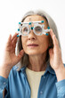 © Maria Vitkovska - Senior woman undergoing eye exam with phoropter for vision correction