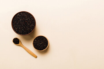 Wall Mural - quinoa seeds in bowl and spoon on colored background. Healthy kinwa in small bowl. Healthy superfood