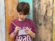 © Tamara Sales  - little boy taking notes