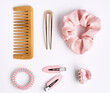 © Tatjana - Hair brush and Collection of elastic band scrunchies and trandy hair clips on white background. Diy accessories and hairstyles concept