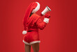 © Dimid - A woman in a red new years swimsuit on a red background holds loudspeaker in hands