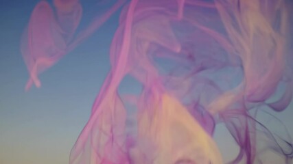 Aufkleber - Colorful smoke swirls beautifully against a clear sky during a sunset display