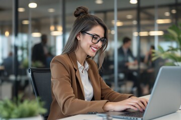 Poster - Businesswoman working on laptop in modern office environment.