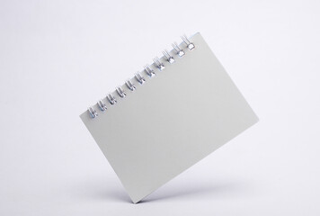 Wall Mural - White notebook floating on white background