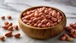 © Joseph - raw peanut seeds in a wooden bowl on a marble countertop dried peeled groundnut as healhy vegetarian snack whole organic monkey nut for dietary nutrition arachis hypogaea fruits