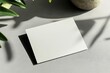 © Maria - mockup of blank business card with embossed edges placed on clean gray surface