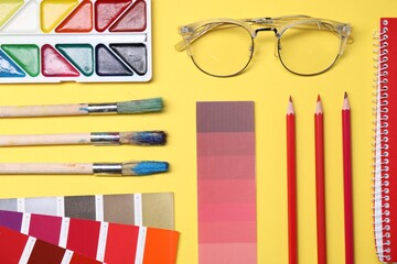Poster - Designer's workplace. Flat lay composition with stationery and glasses on yellow background