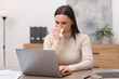 © New Africa - Sick woman with runny nose working at table in office