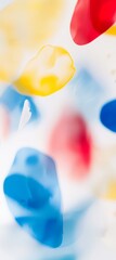 Poster - Colorful ink blobs are gently floating and mixing in a white liquid, creating a vibrant and abstract composition with a dreamy, ethereal quality