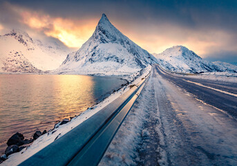 Canvas Print - Dramatic winter view of Lofoten Islands with Volandstind peak. Majestic morning scene of Norway with Fredvang bridge. Great sunrise over polar circle landscape.  Traveling concept background.