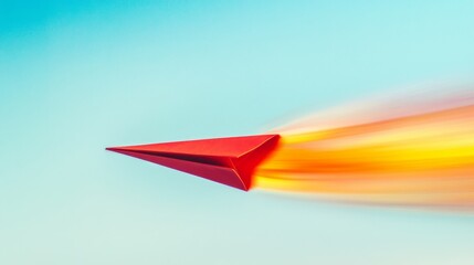 Poster - A close-up of a red and yellow paper plane soaring through the air, with a blur of colors from its path against the clear blue sky