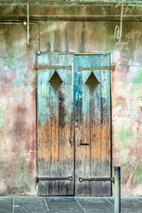 Sticker - old rotten wooden doors with peeling color in the historic district of the French Quarter in New Orleans