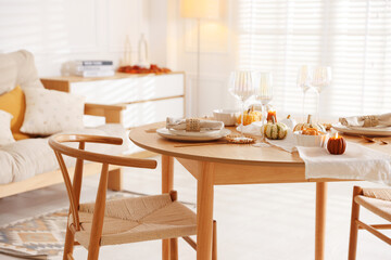 Poster - Stylish table setting with beautiful dishware and autumn decor in dining room