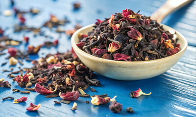 Wall Mural - a mixture of black, red tea with dried fruits and flowers in a bowl