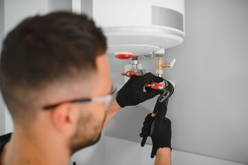 Poster - Professional plumber servicing a boiler