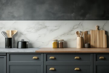 Modern kitchen countertop with marble backsplash, wooden utensils, and dark gray cabinets.