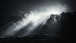 © gentho - A dramatic seascape with light rays breaking through mist over turbulent waters.