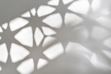 Poster - Abstract shadow pattern creating star shapes on a light surface.