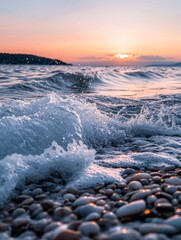 Poster - A serene beach scene at sunset with waves crashing on pebbles.