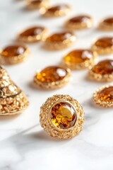 Poster - A collection of ornate golden jewelry with amber stones on a marble surface.